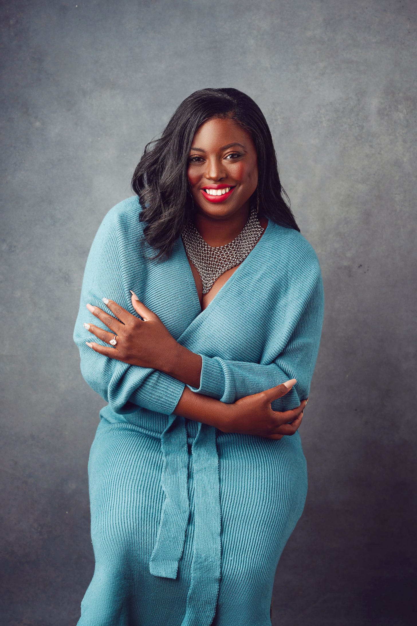 Celeste Lawson in a printed dress seated outdoors in Costa Rica